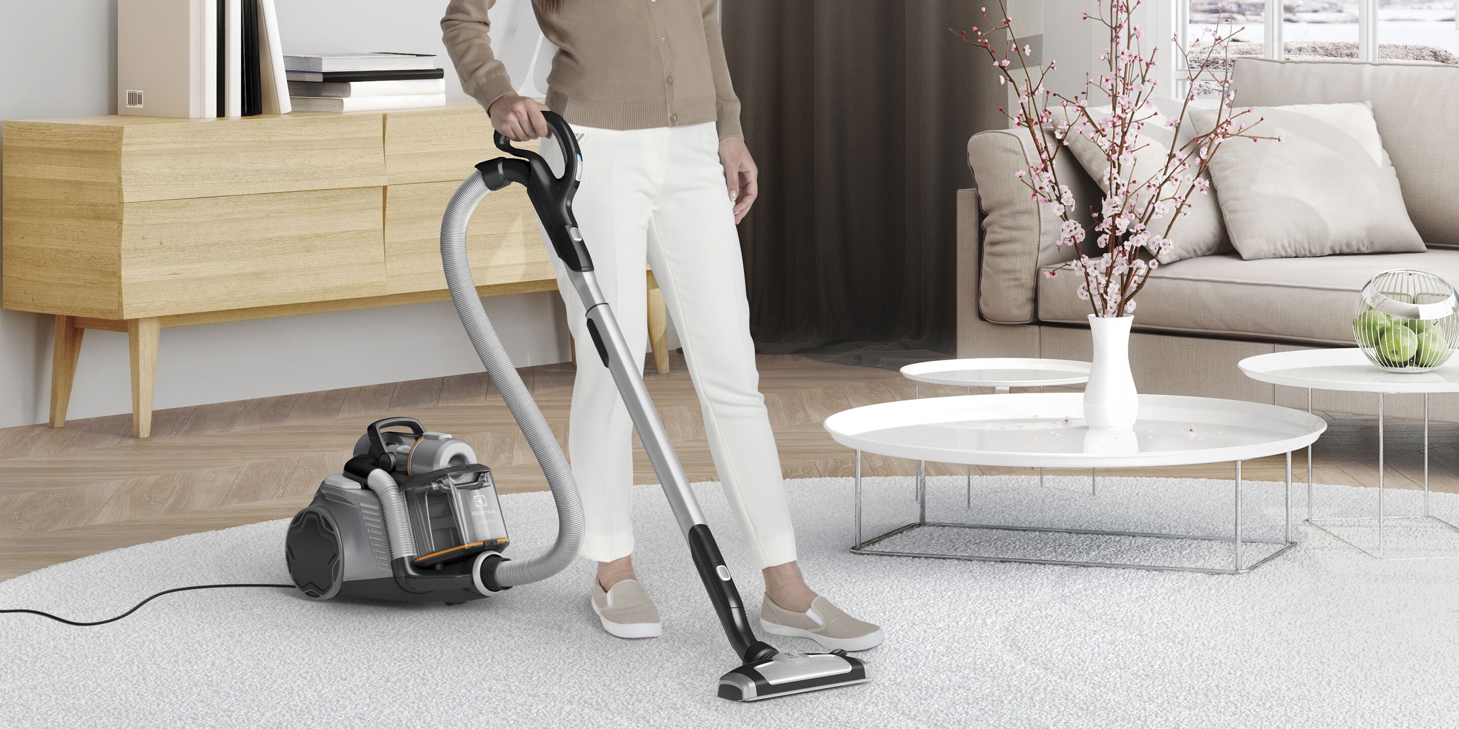 Mulher a limpar uma sala de estar com o aspirador UltraFlex
