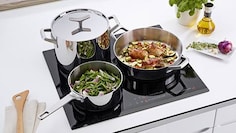 A coleção de recipientes Electrolux Infinite Chef sobre uma placa de indução