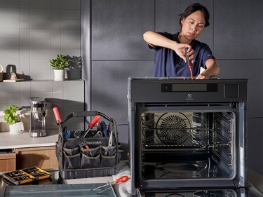 Service technician repairing oven
