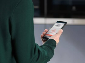 man looking at app on smartphone